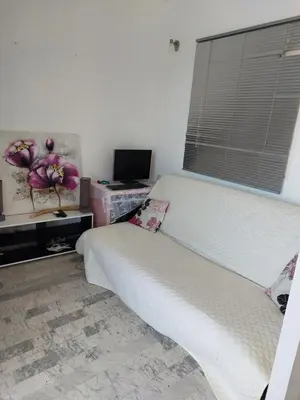 a bedroom with a bed and a television and a window at AJACCIO SANGUINAIRES APPT 3P POUR 4 A 5 P TTES COMMODITÉS TT CONFORT A 300M DE LA MER ET A 5 MN DU CENTRE VILLE in Ajaccio