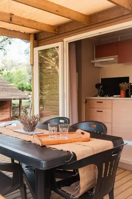 a dining room table with glasses on top of it at CAMPING GALLINA VARJA in Sotta