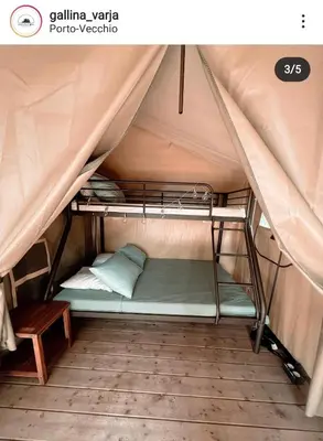 a bunk bed in a tent with a bench at CAMPING GALLINA VARJA in Sotta