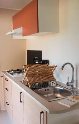 a kitchen with a sink and a stove at CAMPING GALLINA VARJA in Sotta