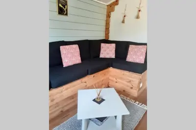 a living room with a blue couch and a table at Chalet Climatisé SANTA MARIA à Bonifacio in Bonifacio