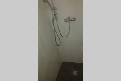 a shower with a shower head in a bathroom at Chalet Climatisé SANTA MARIA à Bonifacio in Bonifacio