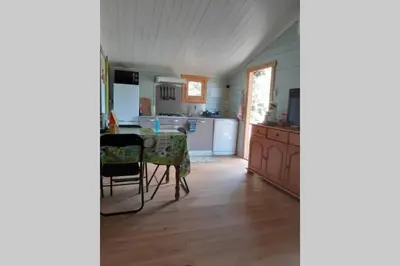 a kitchen with a table and a dining room at Chalet Climatisé SANTA MARIA à Bonifacio in Bonifacio