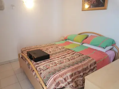 a bed with a suitcase sitting on top of it at ORO 61 in Conca
