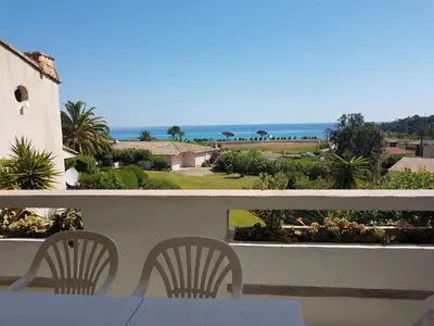 a table and chairs on a balcony with a view of the ocean at ORO 61 in Conca
