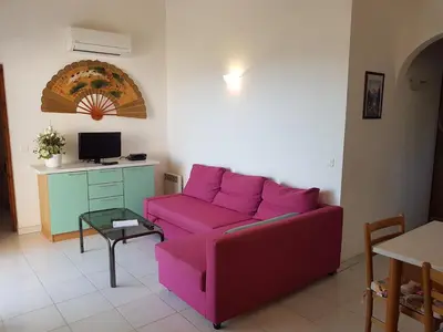 a living room with a pink couch and a table at ORO 61 in Conca