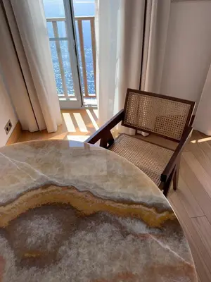 a living room with a table and a chair at Entre Ciel et Mer hotel in Bonifacio