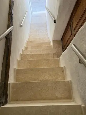 a stairway with concrete steps in a building at Entre Ciel et Mer hotel in Bonifacio