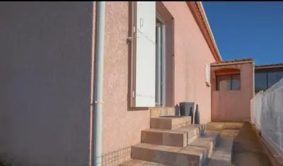 a set of stairs leading to a building with a window at Logement calme et agréable à proximité d'Ajaccio in Canale