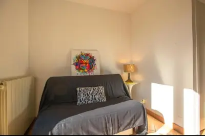 a bedroom with a bed with a pillow on it at Logement calme et agréable à proximité d'Ajaccio in Canale