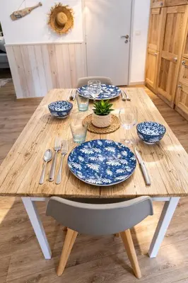 a kitchen with a table and a desk in it at L'Alizia in Sari Solenzara