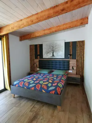 a bedroom with a bed and a wooden ceiling at Mini Villa Giuseppina in Bonifacio