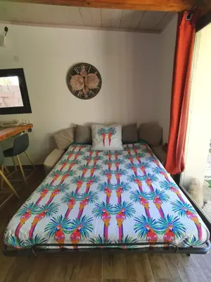 a bed in a room with a colorful comforter at Mini Villa Giuseppina in Bonifacio