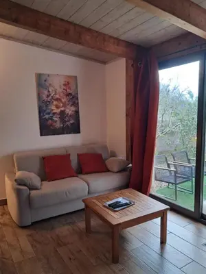 a living room with a couch and a table at Mini Villa Giuseppina in Bonifacio