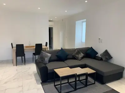 a living room with a couch and a table at Au cœur de sartene in Sartène