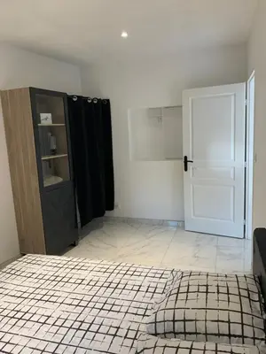 a room with a black door and a tiled floor at Au cœur de sartene in Sartène