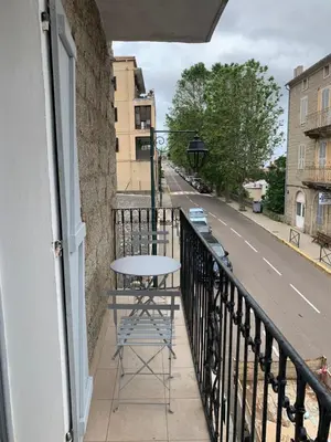a table on the balcony of a building at Au cœur de sartene in Sartène