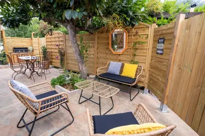 a patio with chairs and a table and a fence at Casa Cardiccia in Folelli
