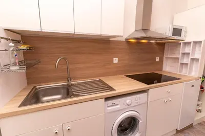 a kitchen with a sink and a washing machine at Casa Cardiccia in Folelli