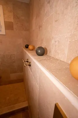 a bathroom with a shower with balls on a counter at Casa Cardiccia in Folelli