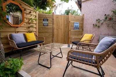 a patio with two chairs and a table and a fence at Casa Cardiccia in Folelli