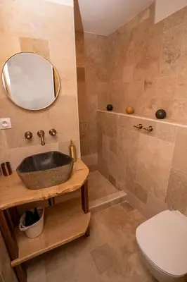 a bathroom with a sink and a toilet and a mirror at Casa Cardiccia in Folelli