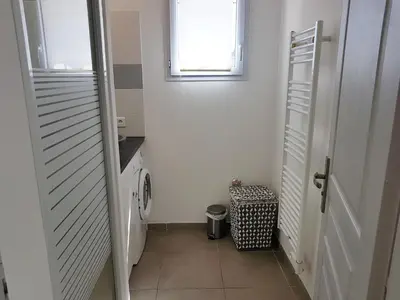 a small bathroom with a toilet and a window at SANTA LUCIA in Sainte-Lucie de Porto-Vecchio