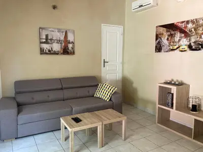 a living room with a couch and a table at Petite maison de campagne in Bonifacio