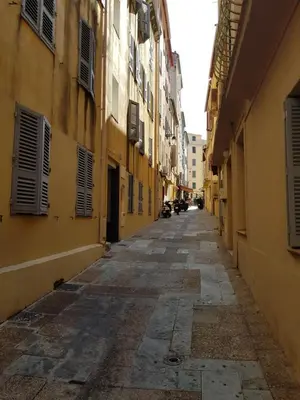 an alley with yellow buildings and an empty street at VIEILLE VILLE D AJACCIO de 1 a 4 PERs A 300M DU PORT ET A 15 MN DE LAEROPORT PROCHES DE PLUS BELLES PLAGES ET TTES COMMODITES A PROXIMITE in Ajaccio