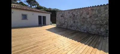 a patio with a stone wall next to a building at Maison vue mer Propriano Viggianello in Viggianello