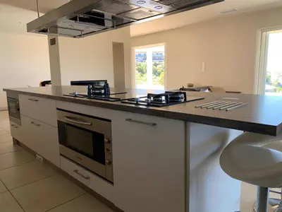 a kitchen with a stove and a counter top at Maison vue mer Propriano Viggianello in Viggianello