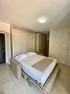 a bedroom with a large bed in a room at STUDIO TERRASSE VUE MER Clim Wifi Parking in Partinello