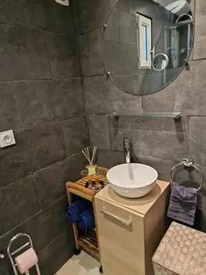 a bathroom with a sink and a mirror at Maisonnette U Santu Ghjuvandria ou A Santa Ghjulia entre mer et Montagne in Volpajola