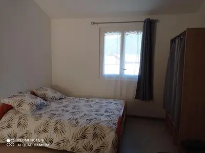 a small bedroom with a bed and a window at Maisonnette U Santu Ghjuvandria ou A Santa Ghjulia entre mer et Montagne in Volpajola