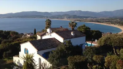 a house on a hill next to a body of water at Villa vue sur mer Corse Blanca Casa à PORTICCIO AJACCIO in Grosseto-Prugna