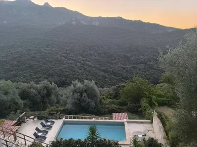 a swimming pool with a view of a mountain at Casa Stella in Olmeto