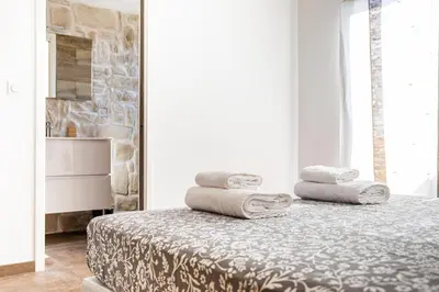 a bedroom with a bed with towels on it at Villa Bianca in Zonza