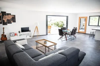 a living room with a couch and a table at Villa Bianca in Zonza