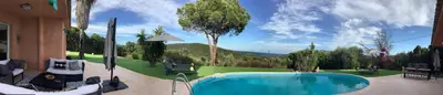a swimming pool in a yard with trees and a mountain at Villa AZURA, vue panoramique et proche mer à Santa Giulia, piscine chauffée in Porto-Vecchio