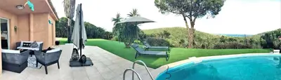 a backyard with a swimming pool and a house with a lawn at Villa AZURA, vue panoramique et proche mer à Santa Giulia, piscine chauffée in Porto-Vecchio