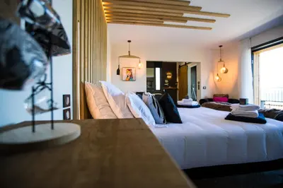 a bedroom with a large white bed with pillows at 