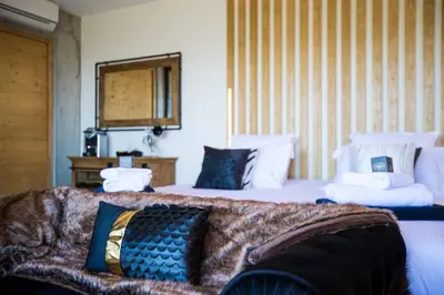 a bedroom with two beds with blue and white pillows at 
