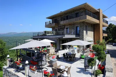 a building with tables and chairs and umbrellas at 