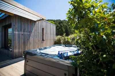 a hot tub sitting on the deck of a house at 