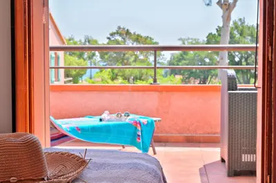 a balcony with a pool table on a patio at Pinea Mare in Poggio-Mezzana