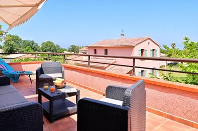 a patio with chairs and a table on a roof at Pinea Mare in Poggio-Mezzana