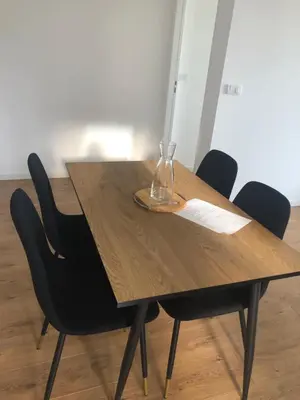 a wooden table with a glass vase on top of it at Ajaccio appartement 4 couchages, climatisé a 150m de la plage route des sanguinaires, parking privé in Ajaccio