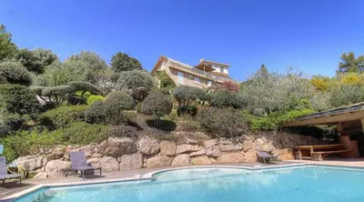 a house on a hill with a swimming pool at Appartement vue mer en Résidence avec piscine in Porto-Vecchio
