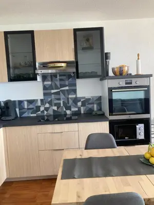 a living room with a couch and a table at Appartement T3 classé 3 étoiles vue mer avec terrasse ,plage 2 minutes à pied in Ajaccio