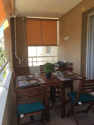 a kitchen with a table and a counter top at Appartement T3 classé 3 étoiles vue mer avec terrasse ,plage 2 minutes à pied in Ajaccio